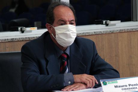 #PraCegoVer: Vereador Mauro Penido acompanha a sessão sentado à sua tribuna. Ele usa uma máscara branca. 